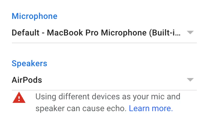 Audio device input and output settings in Google Meet, with a warning that the input and output devices are not the same.